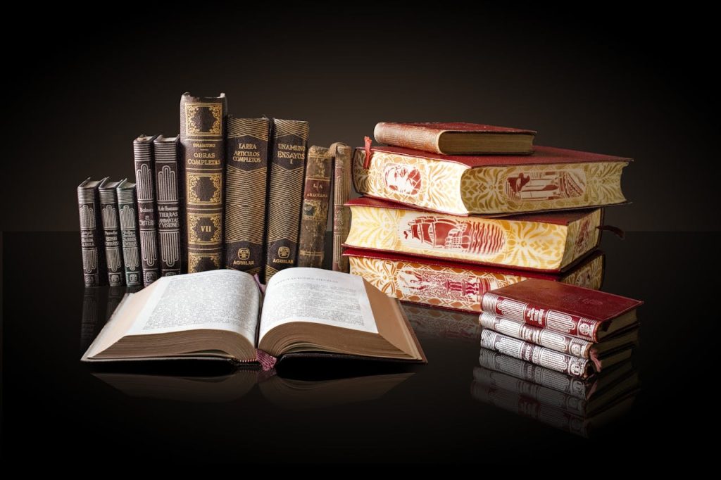 A collection of vintage books displayed elegantly on a reflective surface, ideal for education and literature themes.